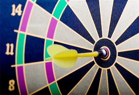 A magnetic dart board with dart(s) at the center (bullseye) Stock Photo - Budget Royalty-Free & Subscription, Code: 400-04574299