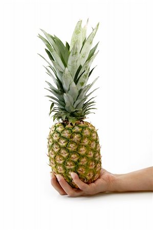 simsearch:400-04650758,k - Womans hand with pineapple on bright background Stock Photo - Budget Royalty-Free & Subscription, Code: 400-04574302
