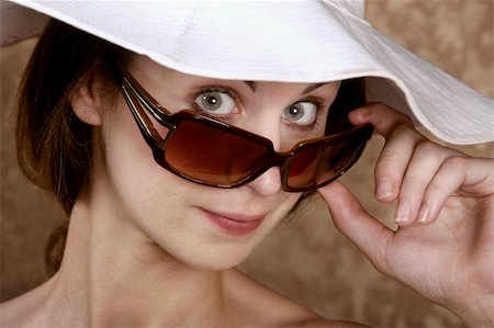 peeping fashion - Young Woman with Sunglasses and a Floppy White Hat Stock Photo - Budget Royalty-Free & Subscription, Code: 400-04574473