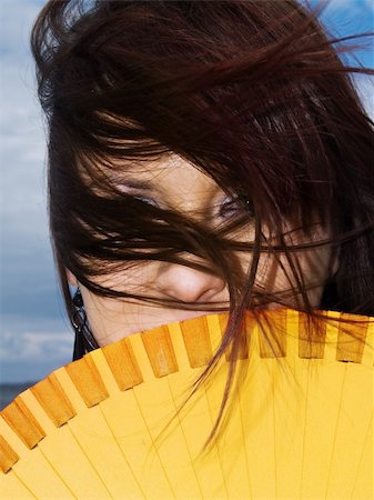 sea fan - woman portrait hiding fan wind yellow long hair Stock Photo - Budget Royalty-Free & Subscription, Code: 400-04574858