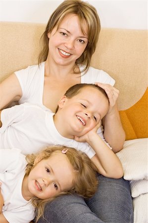 Woman and kids relaxing on the sofa Stock Photo - Budget Royalty-Free & Subscription, Code: 400-04574910