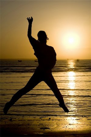 A silhouette of a girl jumping. Stock Photo - Budget Royalty-Free & Subscription, Code: 400-04574938