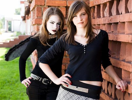 Two Teenager Girls Near The Brick Wall Stock Photo - Budget Royalty-Free & Subscription, Code: 400-04574992