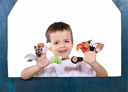 Smiling kid playing with finger puppets - isolated Stock Photo - Budget Royalty-Free & Subscription, Code: 400-04575327