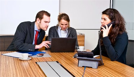 A small business team in a cubicle conference room during a meeting Stock Photo - Budget Royalty-Free & Subscription, Code: 400-04575470