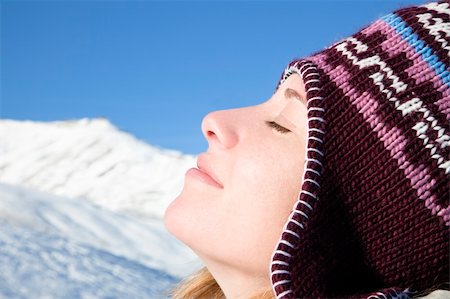 sunbath on snow - side view of young woman enjoying mountain Stock Photo - Budget Royalty-Free & Subscription, Code: 400-04575613