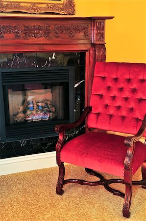 Fireplace and red chair in living room Stock Photo - Budget Royalty-Free & Subscription, Code: 400-04576380