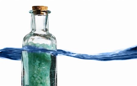 simsearch:400-06479158,k - Bottle of bath salts sitting in a blue wave of water. Stock Photo - Budget Royalty-Free & Subscription, Code: 400-04576670