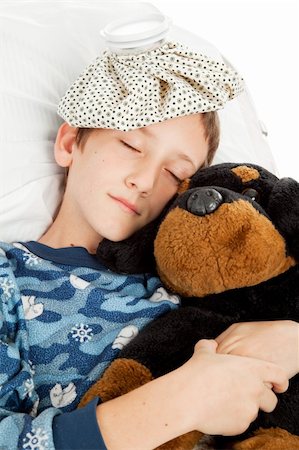 Little boy home sick in bed is sleeping with his stuffed animal. Photographie de stock - Aubaine LD & Abonnement, Code: 400-04577032