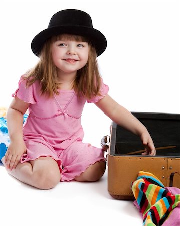 Laughing girl in hat sitting near open retro-styled suitcase Stock Photo - Budget Royalty-Free & Subscription, Code: 400-04577202