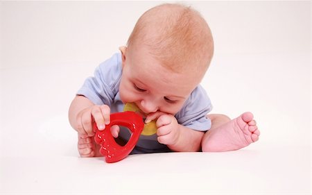 simsearch:400-04161658,k - Portrait of cute newborn playing with rattle Fotografie stock - Microstock e Abbonamento, Codice: 400-04577306