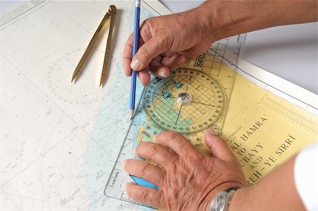 simsearch:400-04206563,k - Plotting With A Drawing Compass, The Old School Method Of Navigation Before The GPS Stock Photo - Budget Royalty-Free & Subscription, Code: 400-04570056
