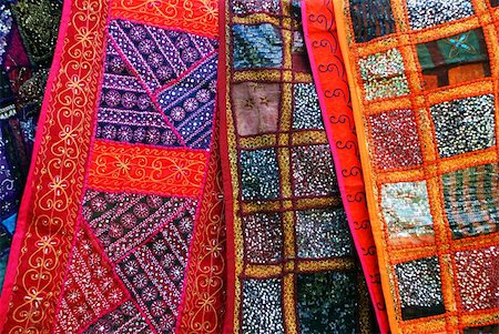 A display of ethnic fabrics, with detailed embroidery and sparkles Foto de stock - Super Valor sin royalties y Suscripción, Código: 400-04570058