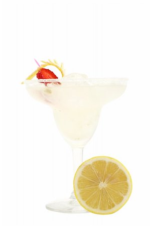 Refreshment Acoholic Drink made of Tequila, Lemon Juice, and Liqueur. Served with salt on the glass rim. Lemon and Strawberry Garnish. Isolated on White Background. Photographie de stock - Aubaine LD & Abonnement, Code: 400-04570151