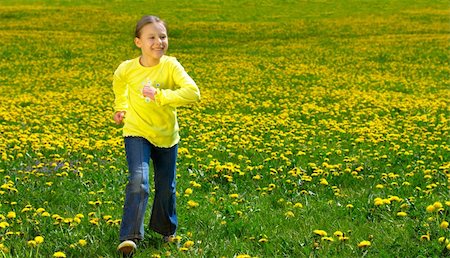 simsearch:400-08262183,k - The girl runs on a green grass with dandelions Stock Photo - Budget Royalty-Free & Subscription, Code: 400-04570226