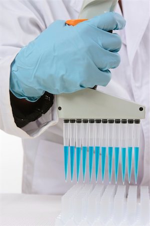 Closeup of a hand holding a digital matrix programmable 850µL multichannel pipetto, used mostly for serological tests, biology and microplate work.  Focus to hand and pipette only. Stock Photo - Budget Royalty-Free & Subscription, Code: 400-04570929