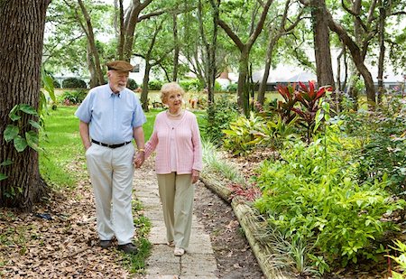 simsearch:400-03972903,k - Senior couple walking through the park together. Stock Photo - Budget Royalty-Free & Subscription, Code: 400-04571320