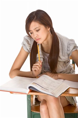 Asian student girl sitting by the desk and studying huge math book, preparing to test Stock Photo - Budget Royalty-Free & Subscription, Code: 400-04571343