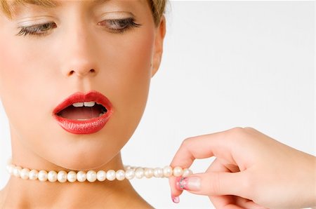 simsearch:400-04209471,k - portrait of a cute girl with red lips and pearls necklace pulling by one hand Photographie de stock - Aubaine LD & Abonnement, Code: 400-04571578