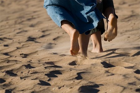 simsearch:400-04912125,k - Barefoot legs on the sand beach. Stock Photo - Budget Royalty-Free & Subscription, Code: 400-04571663