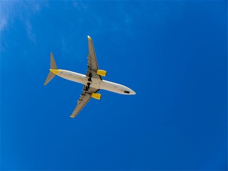 plane flying large sky blue wing - Landing airplane in the blue sky Stock Photo - Budget Royalty-Free & Subscription, Code: 400-04571803