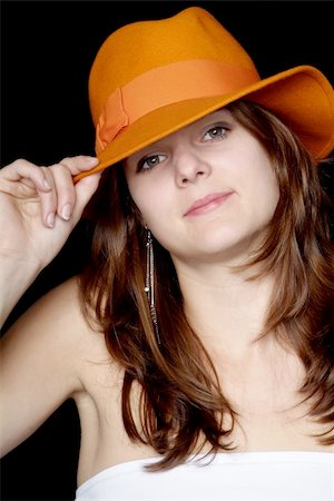 simsearch:400-04996782,k - young woman with long brown hair holds orange hat on head Foto de stock - Super Valor sin royalties y Suscripción, Código: 400-04571829