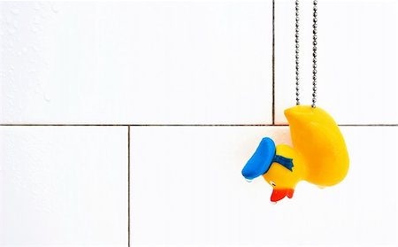 simsearch:400-04240306,k - Small rubber ducky hanging on steel chain in wet shower stall Stock Photo - Budget Royalty-Free & Subscription, Code: 400-04572907