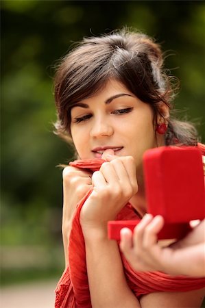 young attractive girl looking at red ring box presented to her by someone Stock Photo - Budget Royalty-Free & Subscription, Code: 400-04573517