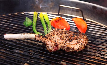 The smoked piece of meat and some vegetables on the grill Stock Photo - Budget Royalty-Free & Subscription, Code: 400-04573562