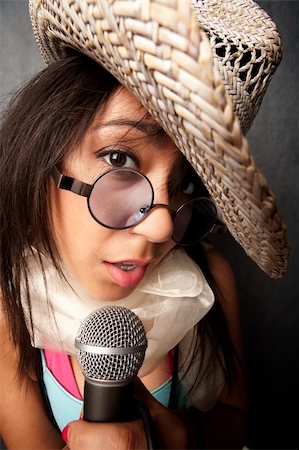 Pretty young singer with a large microphone Stock Photo - Budget Royalty-Free & Subscription, Code: 400-04584657