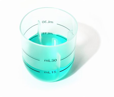Plastic measuring glass containing blue liquid. The blue color is natural. It's a cough medicine. Stock Photo - Budget Royalty-Free & Subscription, Code: 400-04584759