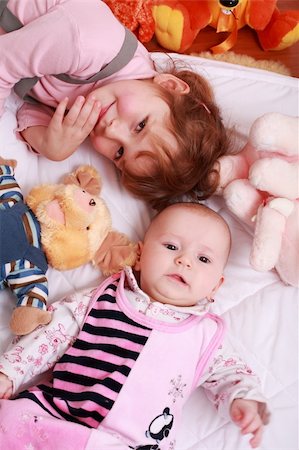 simsearch:400-04637418,k - Cute older sister with small baby and toys Stock Photo - Budget Royalty-Free & Subscription, Code: 400-04584953