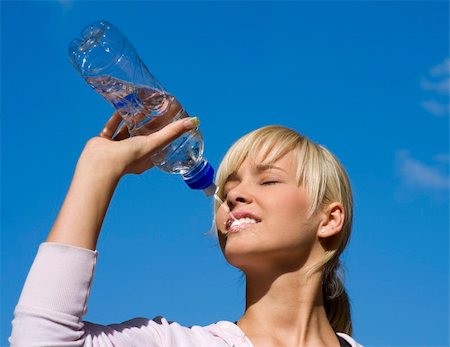 cute blond girl drinking water from a sport bottle Stock Photo - Budget Royalty-Free & Subscription, Code: 400-04585356