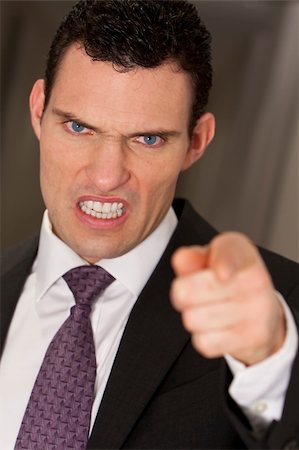 simsearch:400-04333650,k - Close up studio shot of a smartly dressed man reacting angrily to camera Stock Photo - Budget Royalty-Free & Subscription, Code: 400-04585729