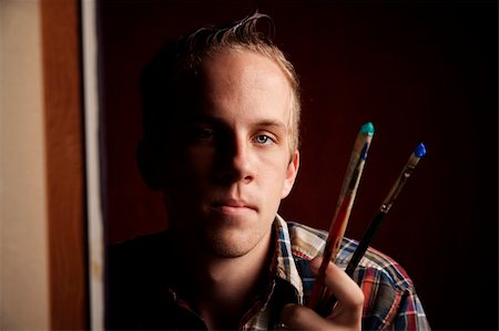 Handsome young artist holding brushes Stock Photo - Budget Royalty-Free & Subscription, Code: 400-04586075