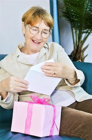 Elderly woman opening birthday card and present Stock Photo - Budget Royalty-Free & Subscription, Code: 400-04586219
