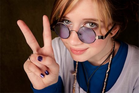 Pretty teen girl making a peace sign with her hand Stock Photo - Budget Royalty-Free & Subscription, Code: 400-04586361