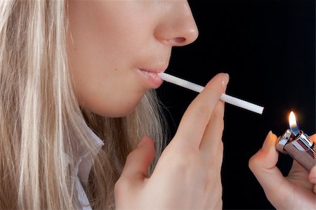 beautiful young girl with lighter smoking cigarette Stock Photo - Budget Royalty-Free & Subscription, Code: 400-04586563