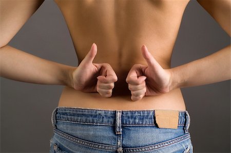 endorsing - Beautiful sexy back of a young successful  woman with thumbs up Stock Photo - Budget Royalty-Free & Subscription, Code: 400-04586858