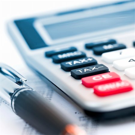 Calculating numbers for income tax return with pen and calculator Stock Photo - Budget Royalty-Free & Subscription, Code: 400-04587190