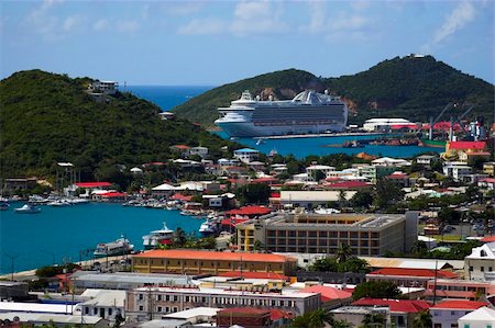 simsearch:625-01041175,k - Tropical town - tropical island with a small red-roof town with the background of the large cruise ship. St. Thomas, USVI Photographie de stock - Aubaine LD & Abonnement, Code: 400-04587290