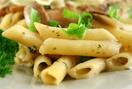 simsearch:400-04055000,k - Creamy mushroom penne pasta with shredded cheese. Photographie de stock - Aubaine LD & Abonnement, Code: 400-04587291