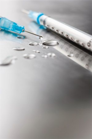 Needles on stainless steel table with  drops of liquid Stock Photo - Budget Royalty-Free & Subscription, Code: 400-04587415