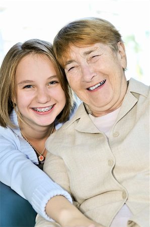 simsearch:400-04300757,k - Teen granddaughter hugging grandmother laughing and smiling Photographie de stock - Aubaine LD & Abonnement, Code: 400-04587604