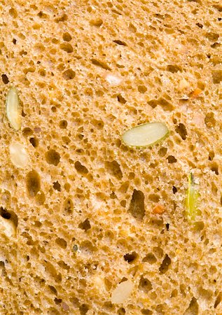 a close up of the texture of a slice of brown bread Foto de stock - Royalty-Free Super Valor e Assinatura, Número: 400-04588063