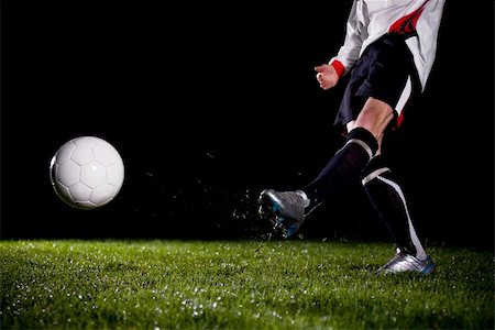 dark people running - soccer player kicking the ball Stock Photo - Budget Royalty-Free & Subscription, Code: 400-04588504