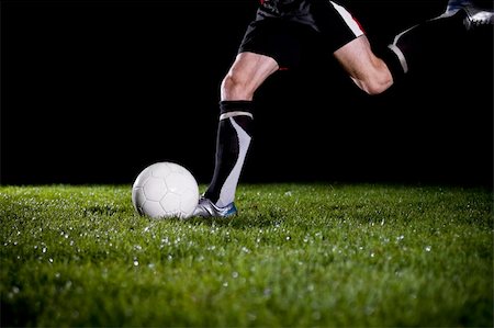 dark people running - soccer player is going to kick the ball Stock Photo - Budget Royalty-Free & Subscription, Code: 400-04588503