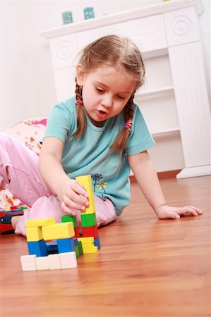 Adorable girl playing with blocks Stock Photo - Budget Royalty-Free & Subscription, Code: 400-04588611