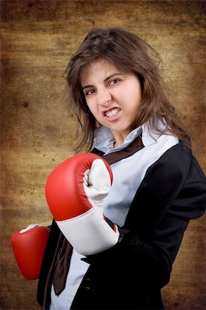 businesswoman with boxing gloves over grunge background Photographie de stock - Aubaine LD & Abonnement, Code: 400-04588639