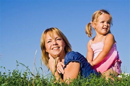 simsearch:400-04795754,k - Woman and little girl laying in the grass against sunny summer sky Stock Photo - Budget Royalty-Free & Subscription, Code: 400-04588731